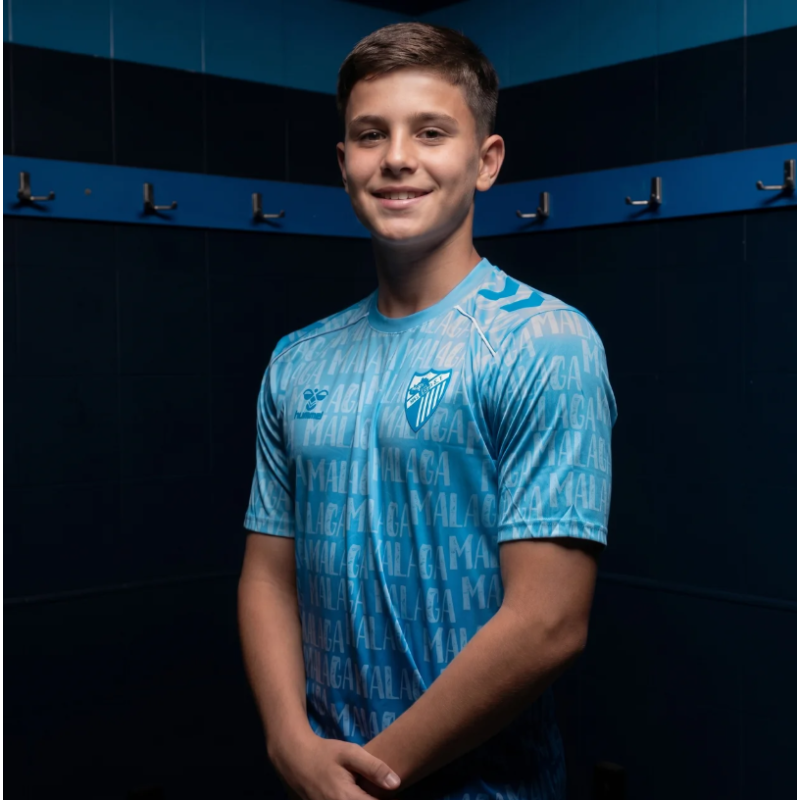 MALAGA CF OFFICIAL PREMATCH LETTERED T‑SHIRT 2025/26 –JUNIOR–